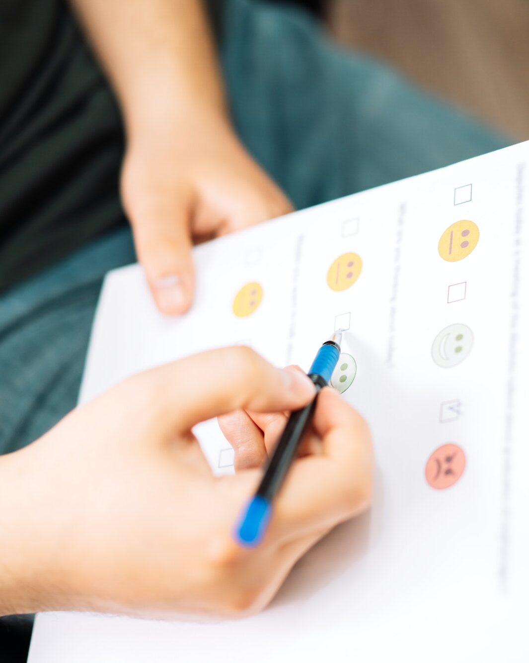 Man taking a psychological test with emoticons