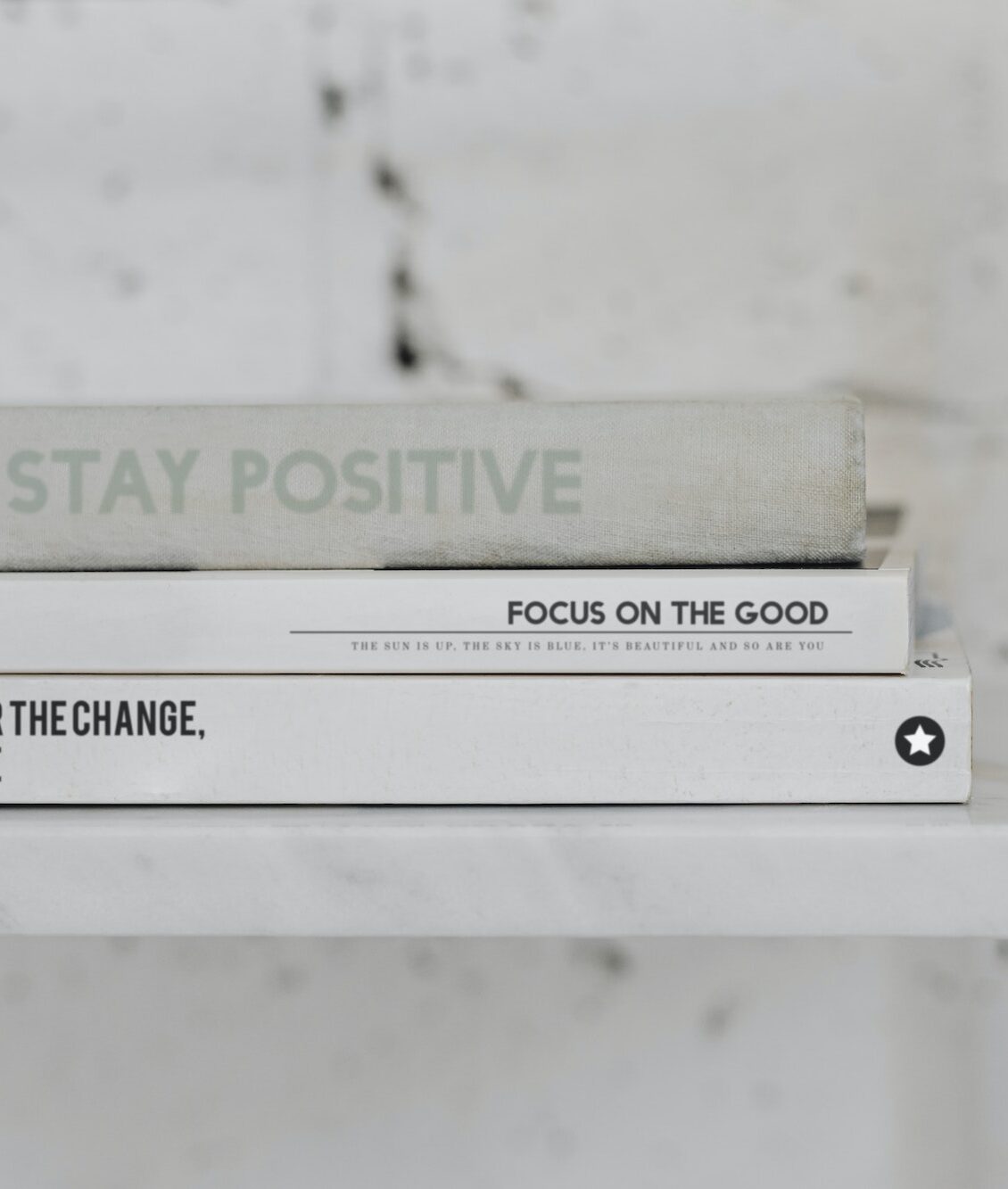 Stack of psychology books on a white marble shelf